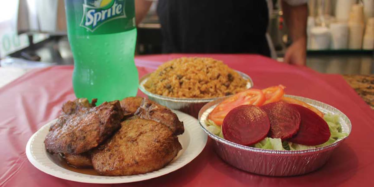 Dominican catering trays of chicken, rice, and plantains from Sazon Perez